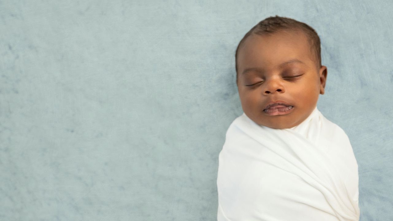 newborn baby wrapped in a swaddle