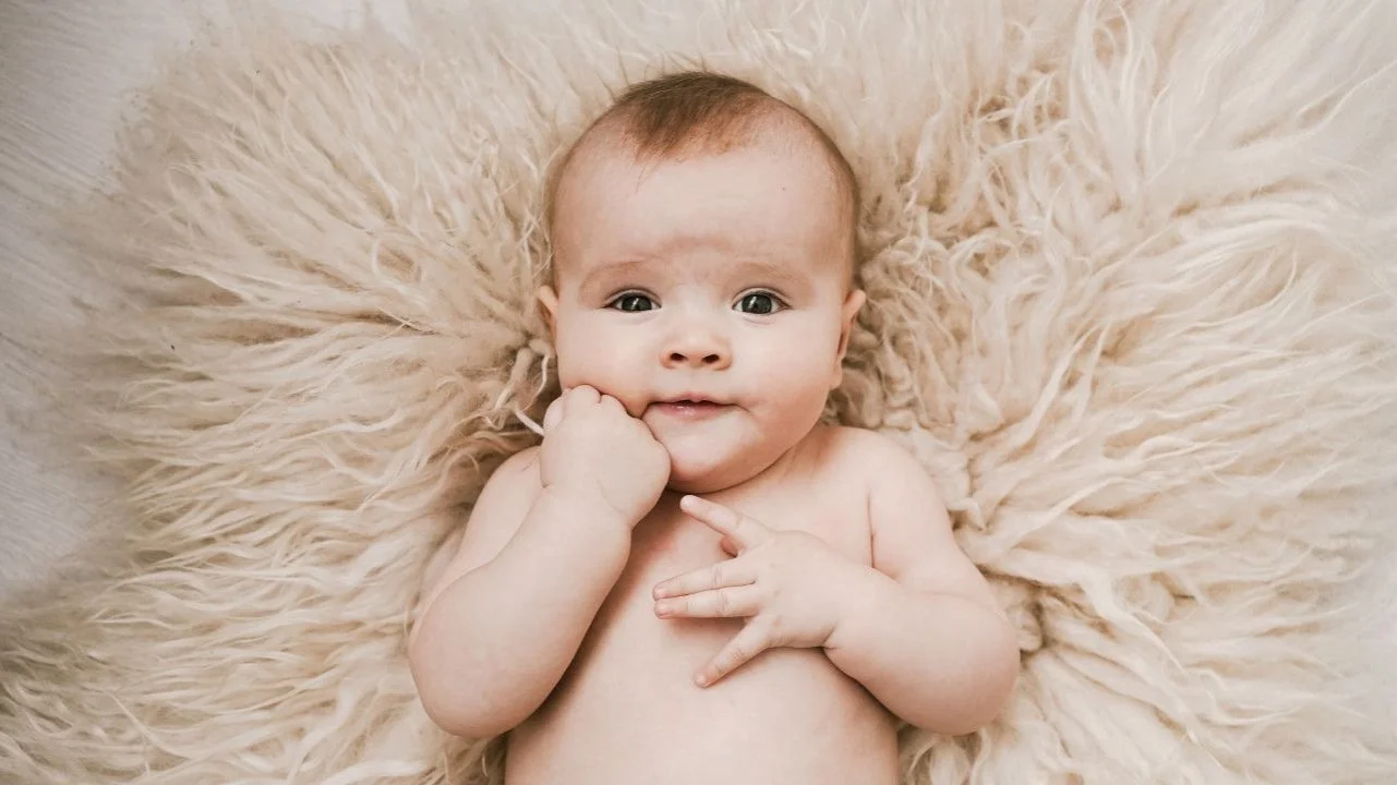 baby laying on a blanket