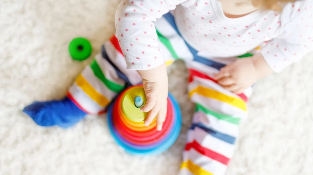 toddler playing with stacking rings