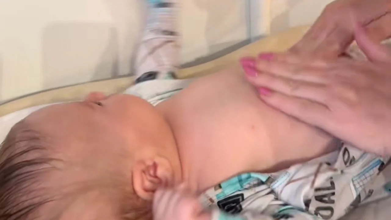 baby getting massaged on its belly