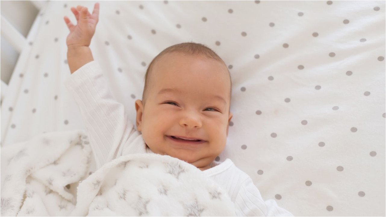 baby smiling awake in crib