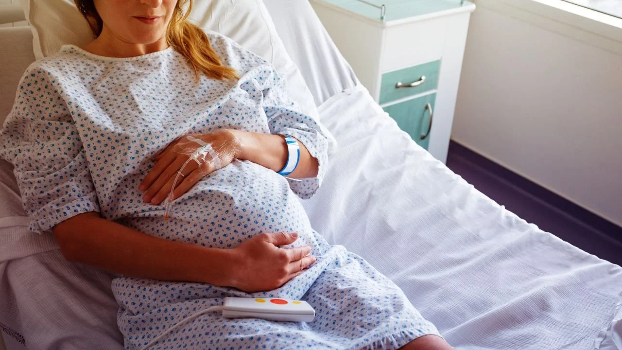 pregnant woman in hospital bed before delivery