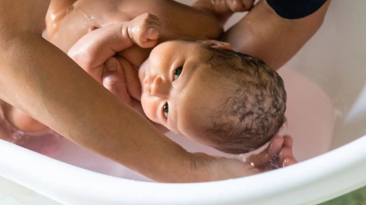 newborn in a bath tub