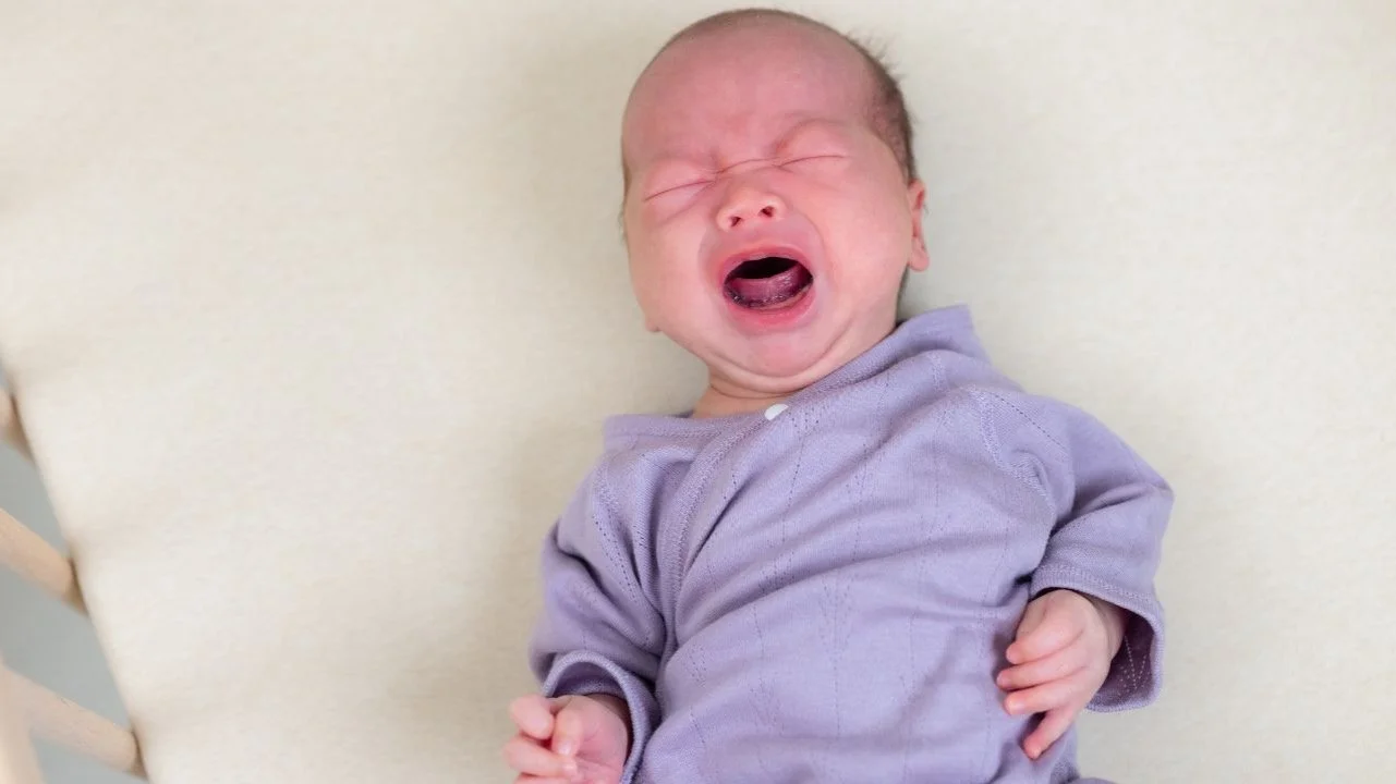 baby crying in crib