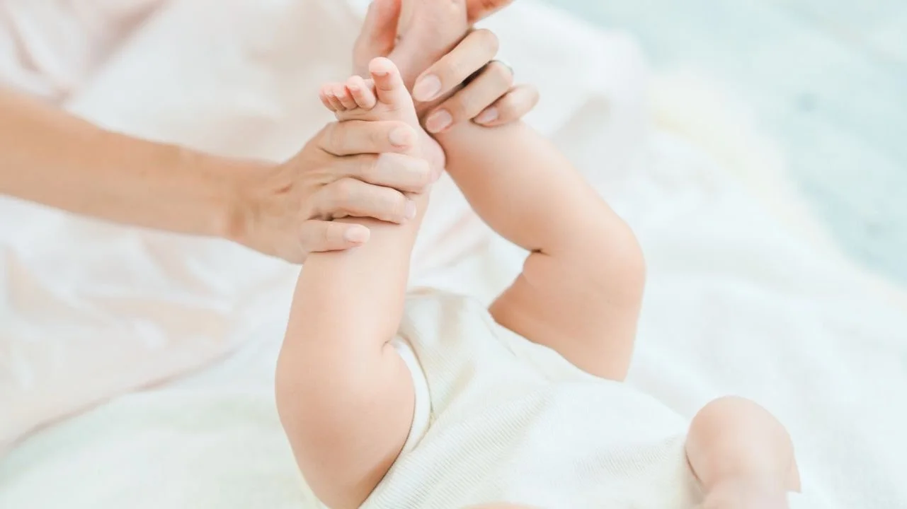 lifting baby's legs up