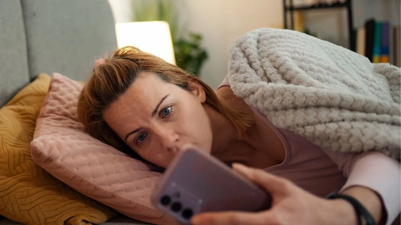woman doomscrolling on her phone before bed