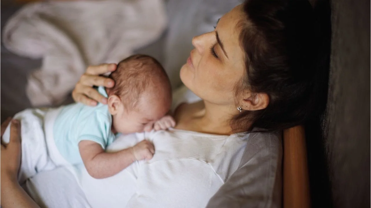 woman holding newborn baby