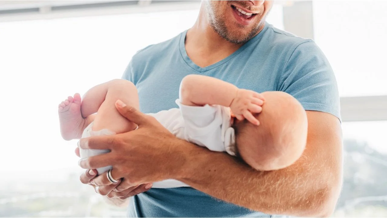 dad holding baby