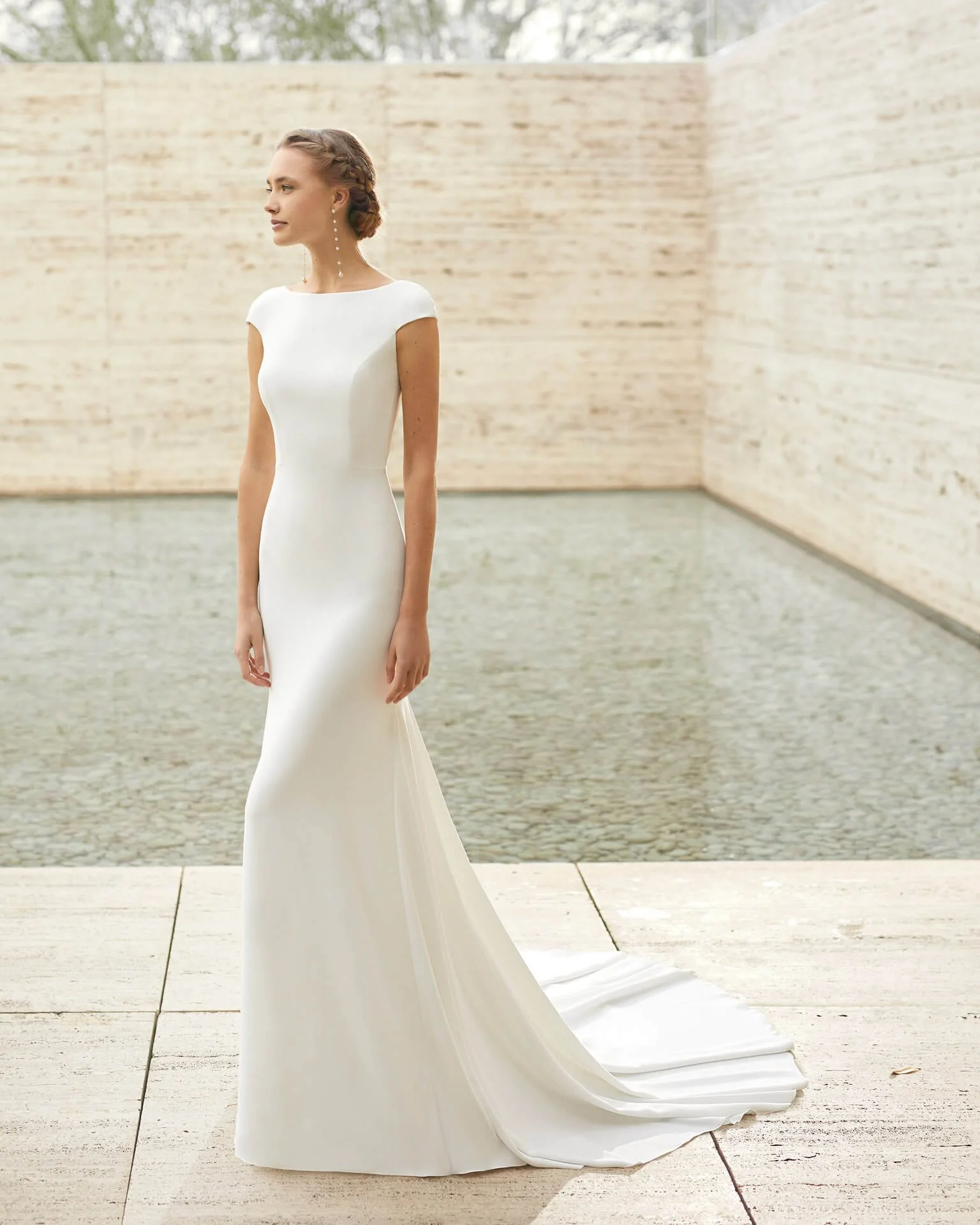Bride near pool in a crepe fit and Flare bridal dress at Ashley and Alexandrias Belleville Michigan