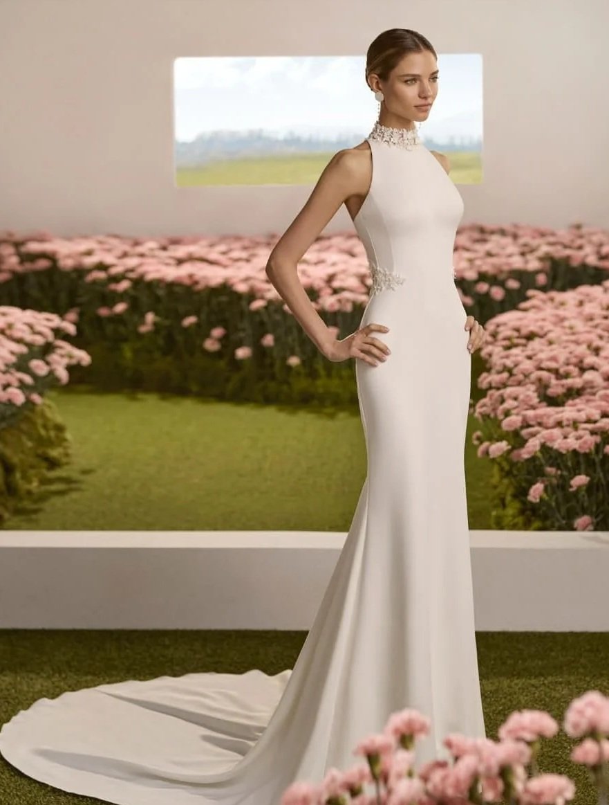 Beautiful Bride wearing a Rosa Clara crepe sheath applique bodice wedding dress in studio filled with flowers in Ashley and Alexandrias Bridal boutique Southfield Michigan