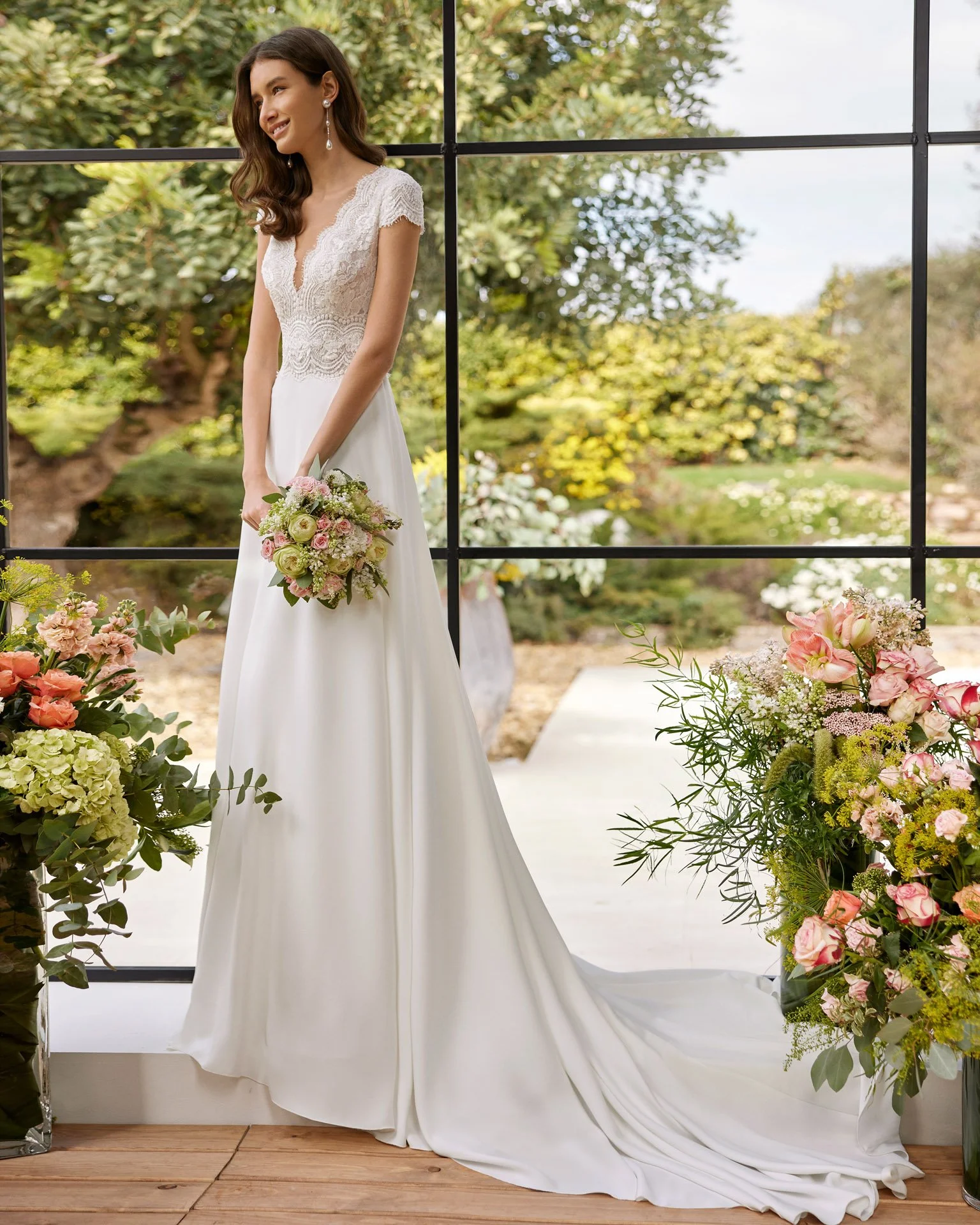 Bride wearing a beautiful bridal gown from Rosa Clara Couture Crepe and lace with beading A-Line wedding dress at Ashley and Alexandrias Royal Oak Michigan