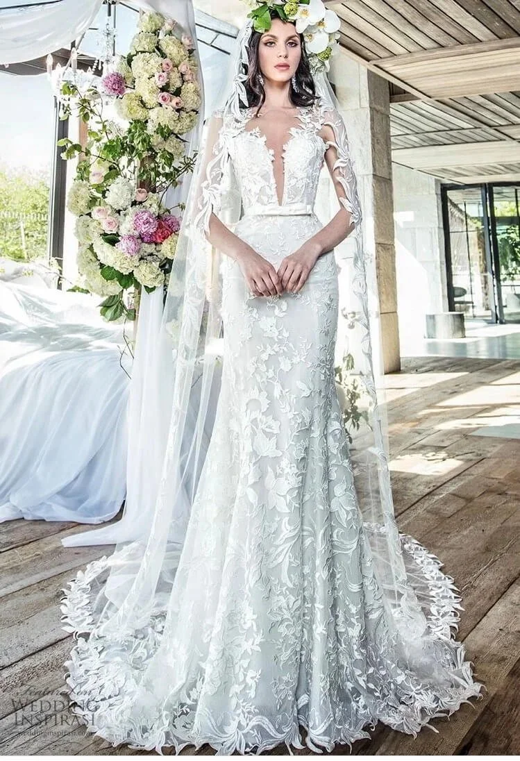 Bride modeling Yumi Katsura lace fit and flare wedding dress in beautiful garden of open home concept matching veil and floral arrangement Ashley and Alexandrias Bridal Metro Detroit Area