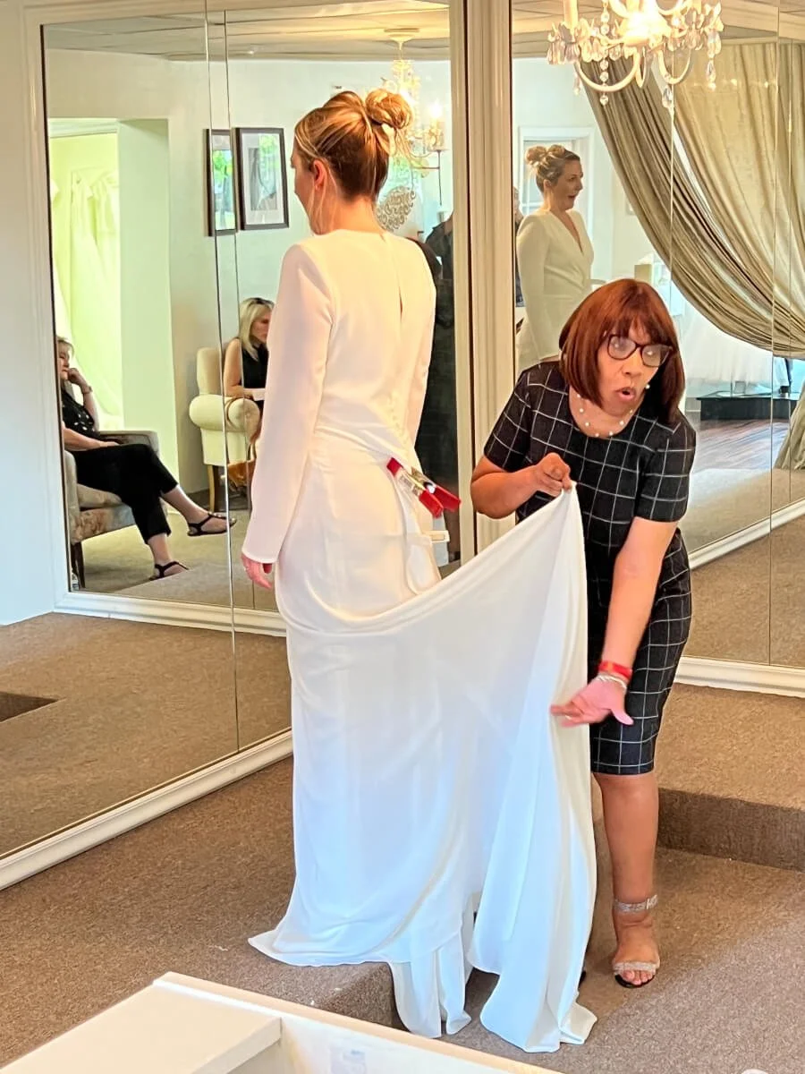 Bride realizing this is the wedding dress that most explemplify her personality Rosa Clara Couture Bridal with bridal stylist collection exclusively at Ashley and Alexandrias Bridal Atelier Southfield Michigan