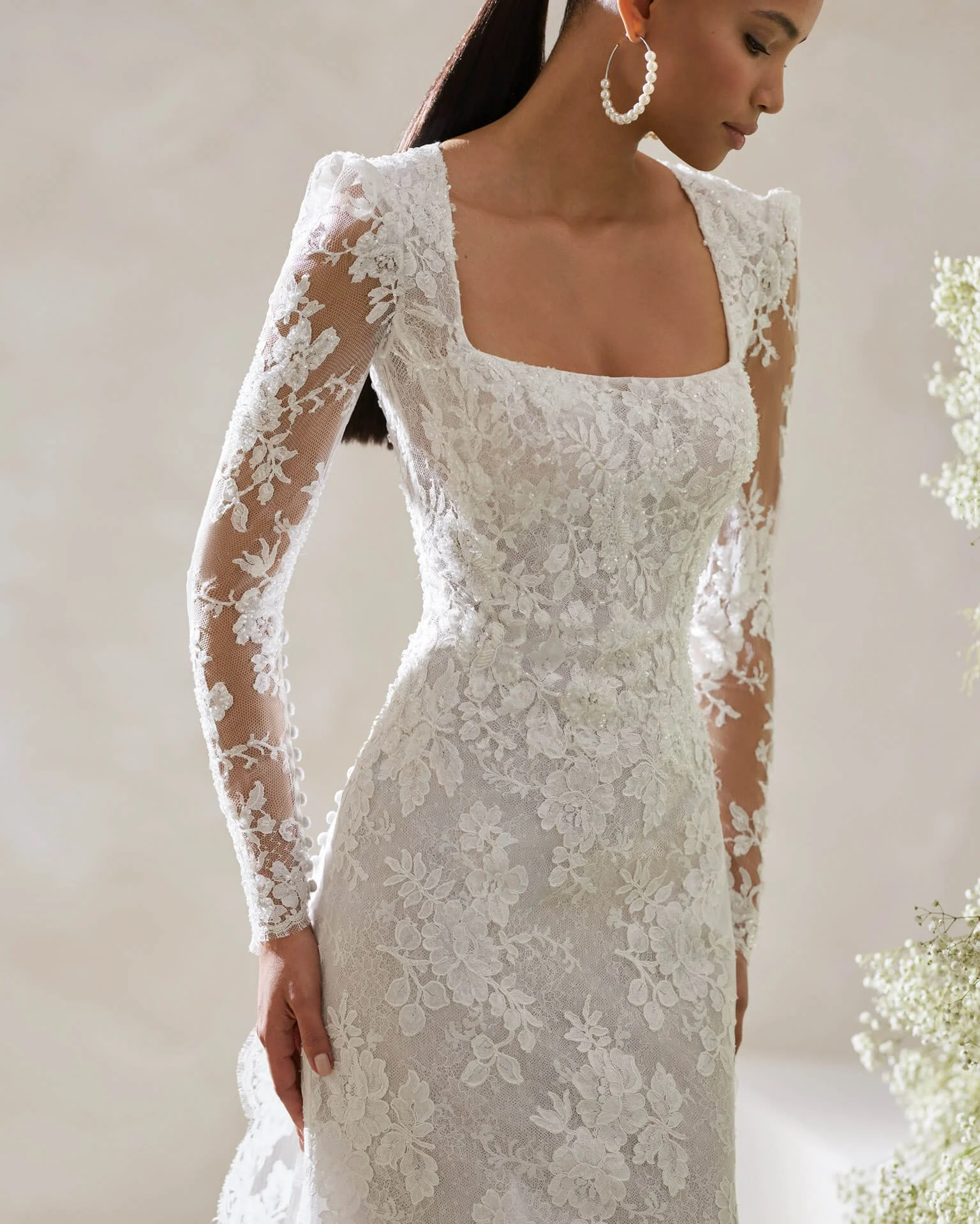 Bride in a neutral room wearing a Rosa Clara Couture lace and beaded sheeth wedding dress Ashley and Alexandrias Novi Michigan