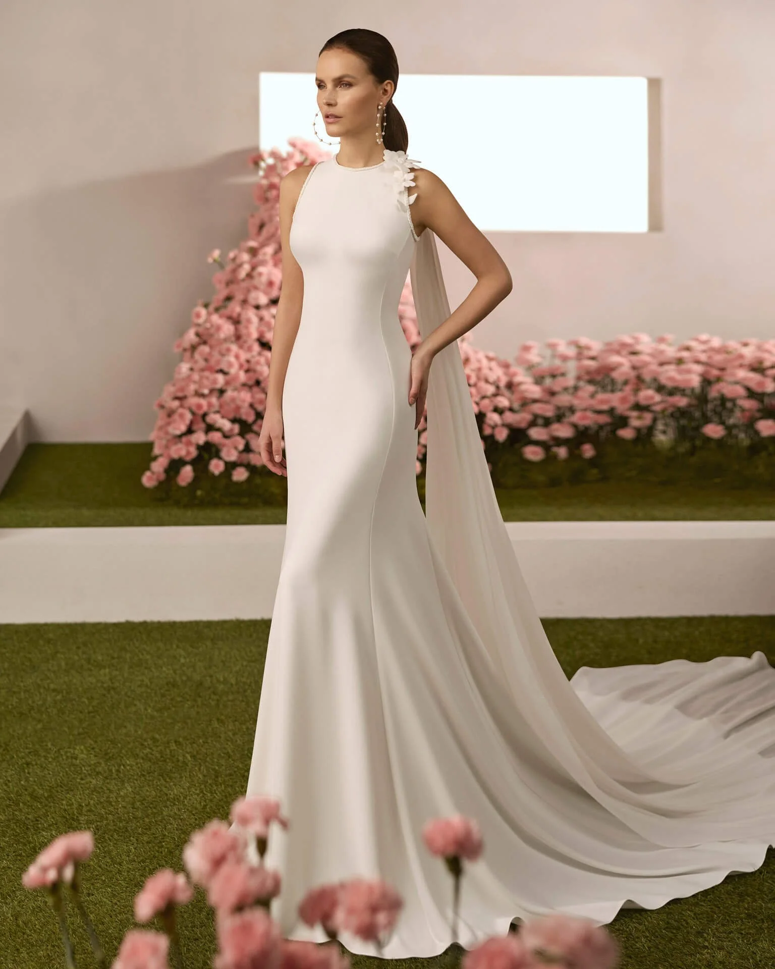 Bride in a garden hallway wearing a Rosa Clara Couture Mermaid wedding Dress with attachment Regno at Ashley and Alexandrias Bridal Atelier Southfield Michigan