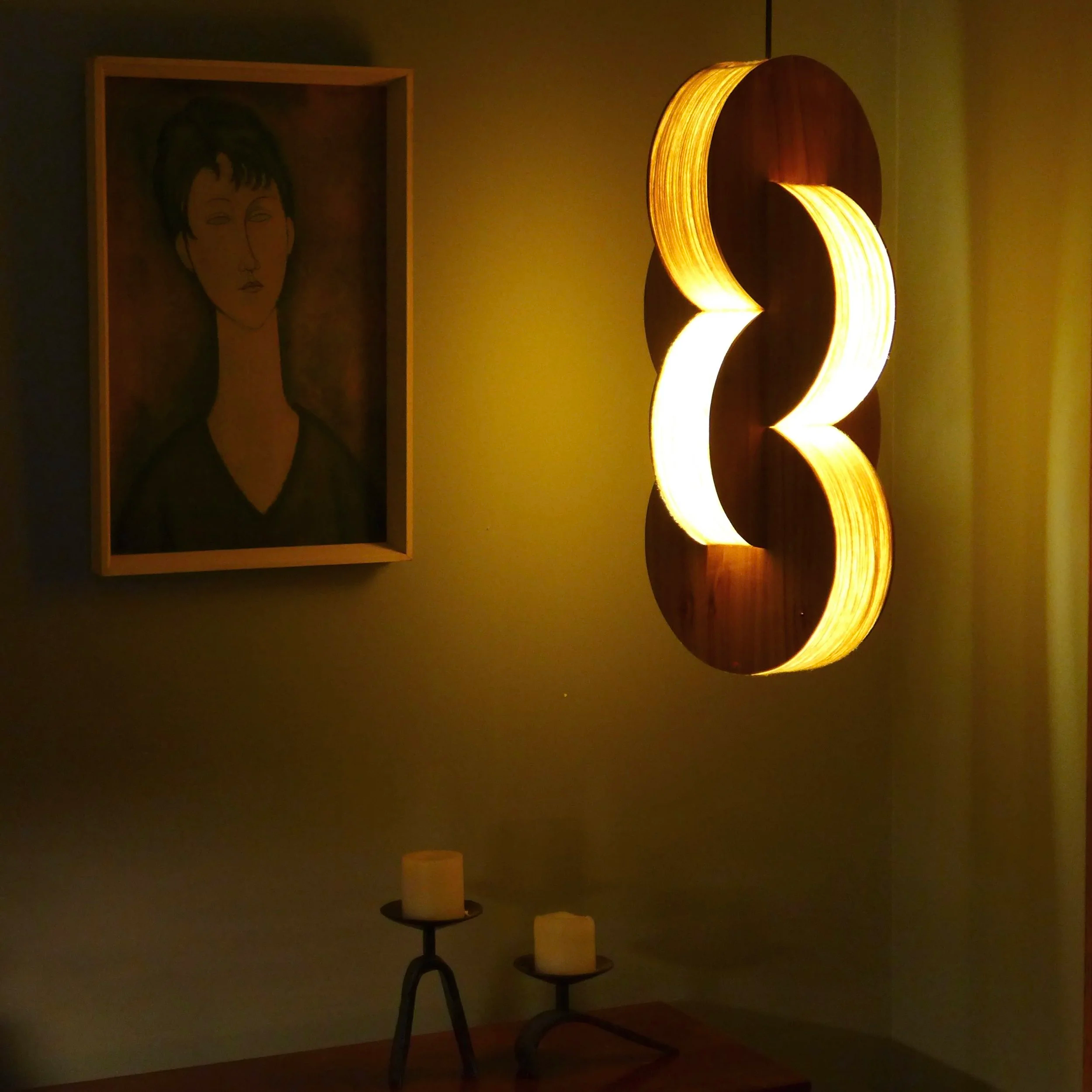 A modern art sculpture with illuminated curved wooden panels.