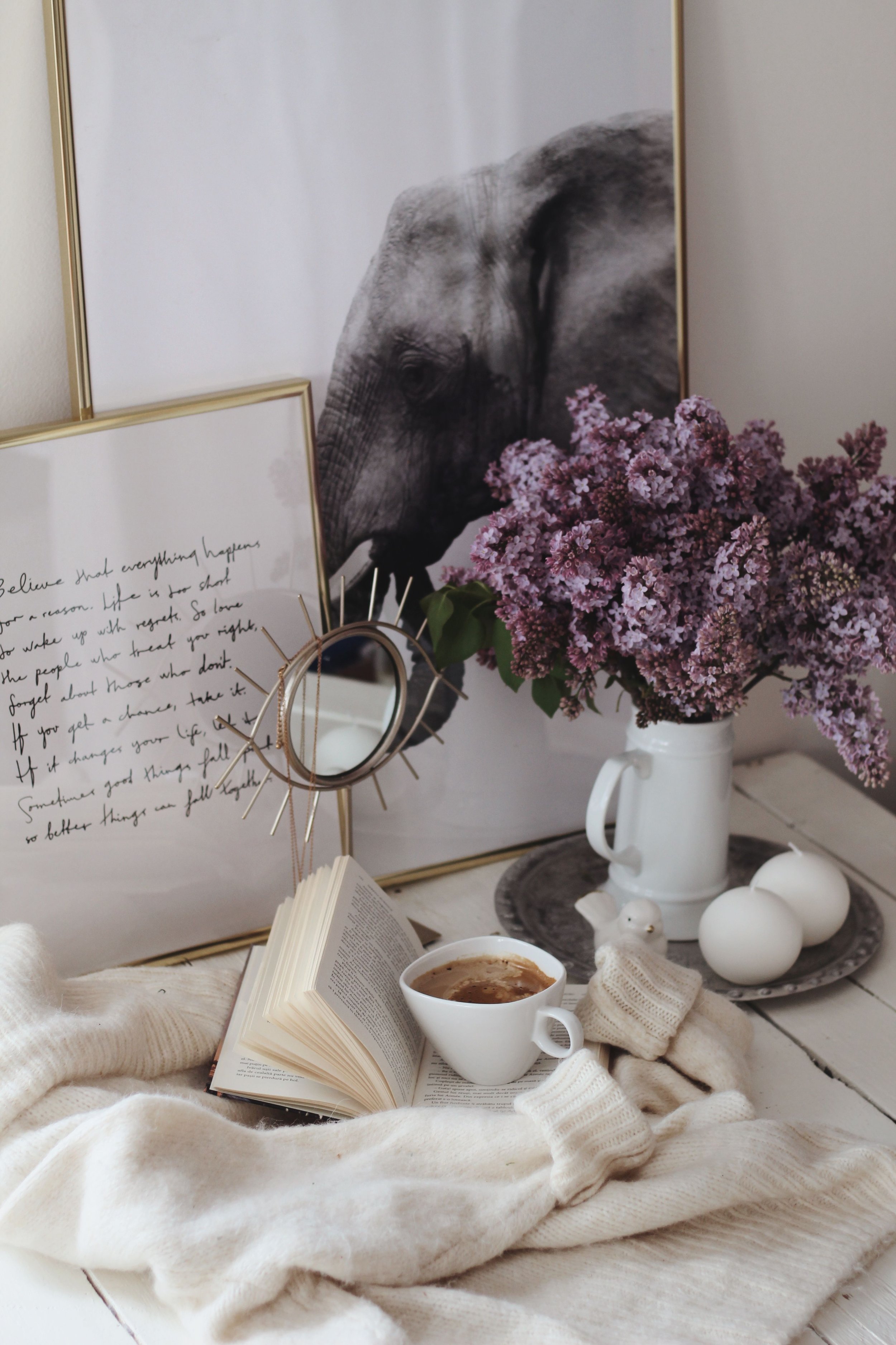 Cozy reading space with flowers, coffee and an open book
