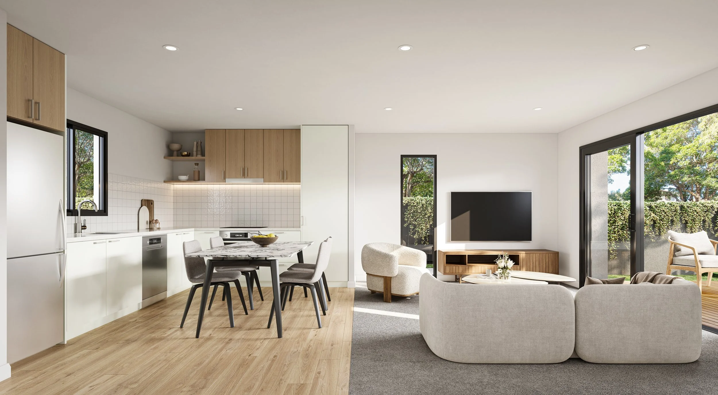 Open-concept living room and kitchen with natural light, white and wooden decor, flat-screen TV, dining table with four chairs, and sliding glass doors leading to an outdoor patio.