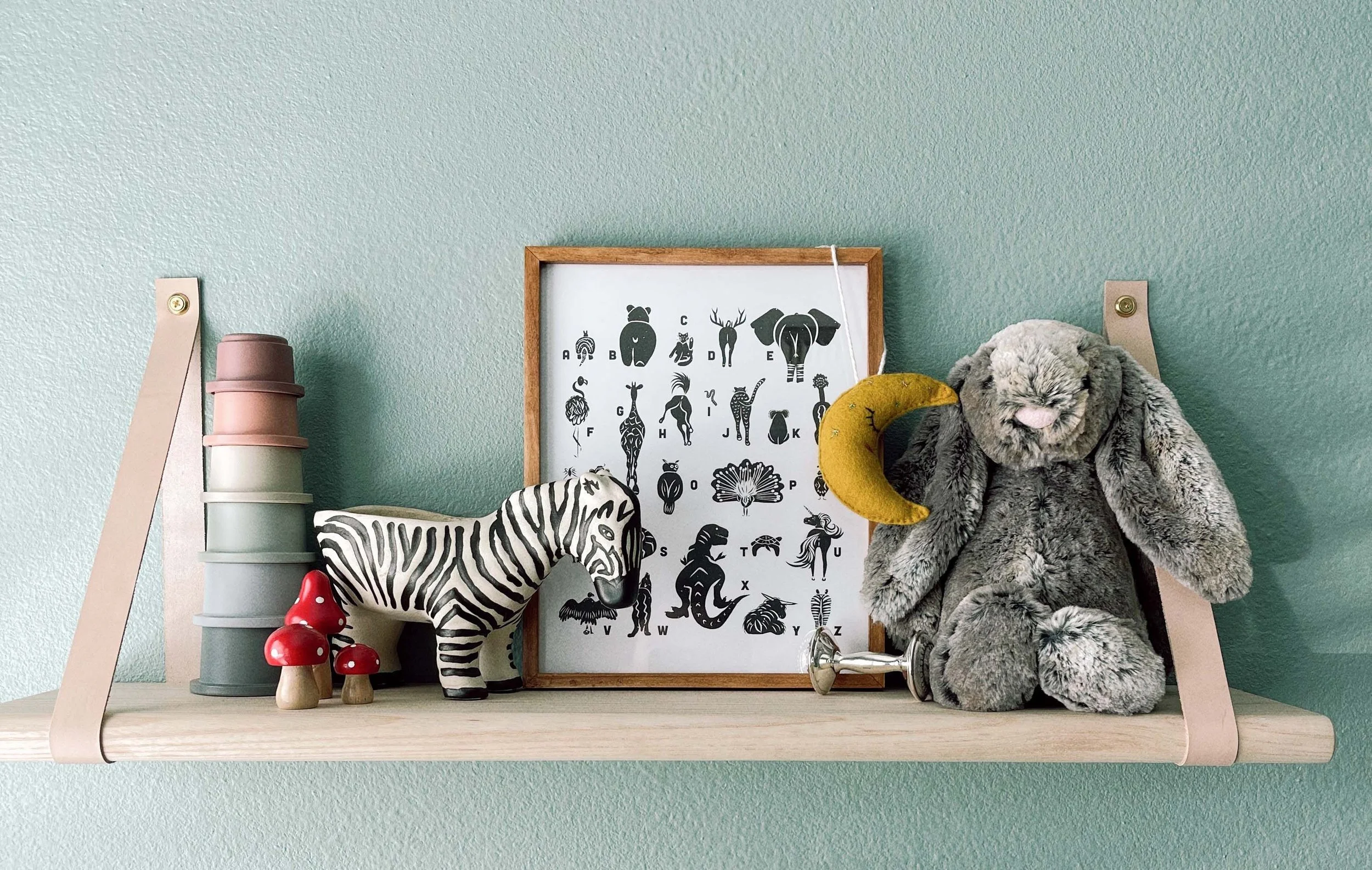 Animal Butt Alphabet print on display in a nursery.