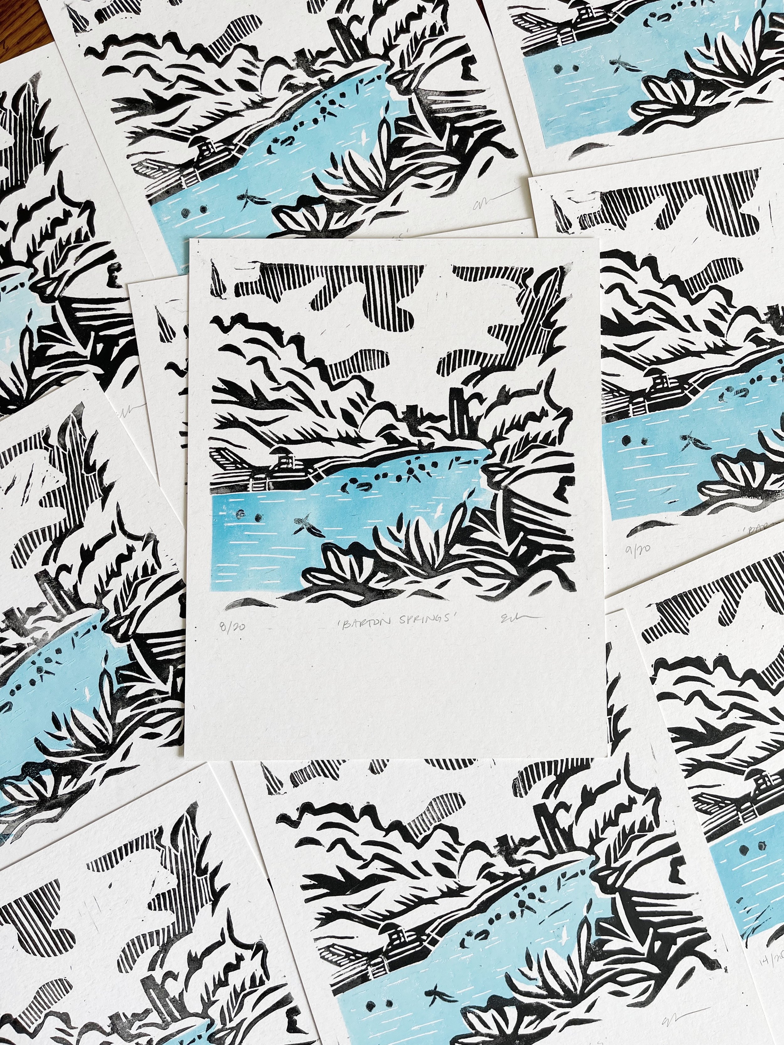 A stack of Barton Springs linocut prints