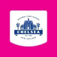 Logo of Chelsea Natural Cane Sugars from New Zealand with a building and plant design on a pink background.