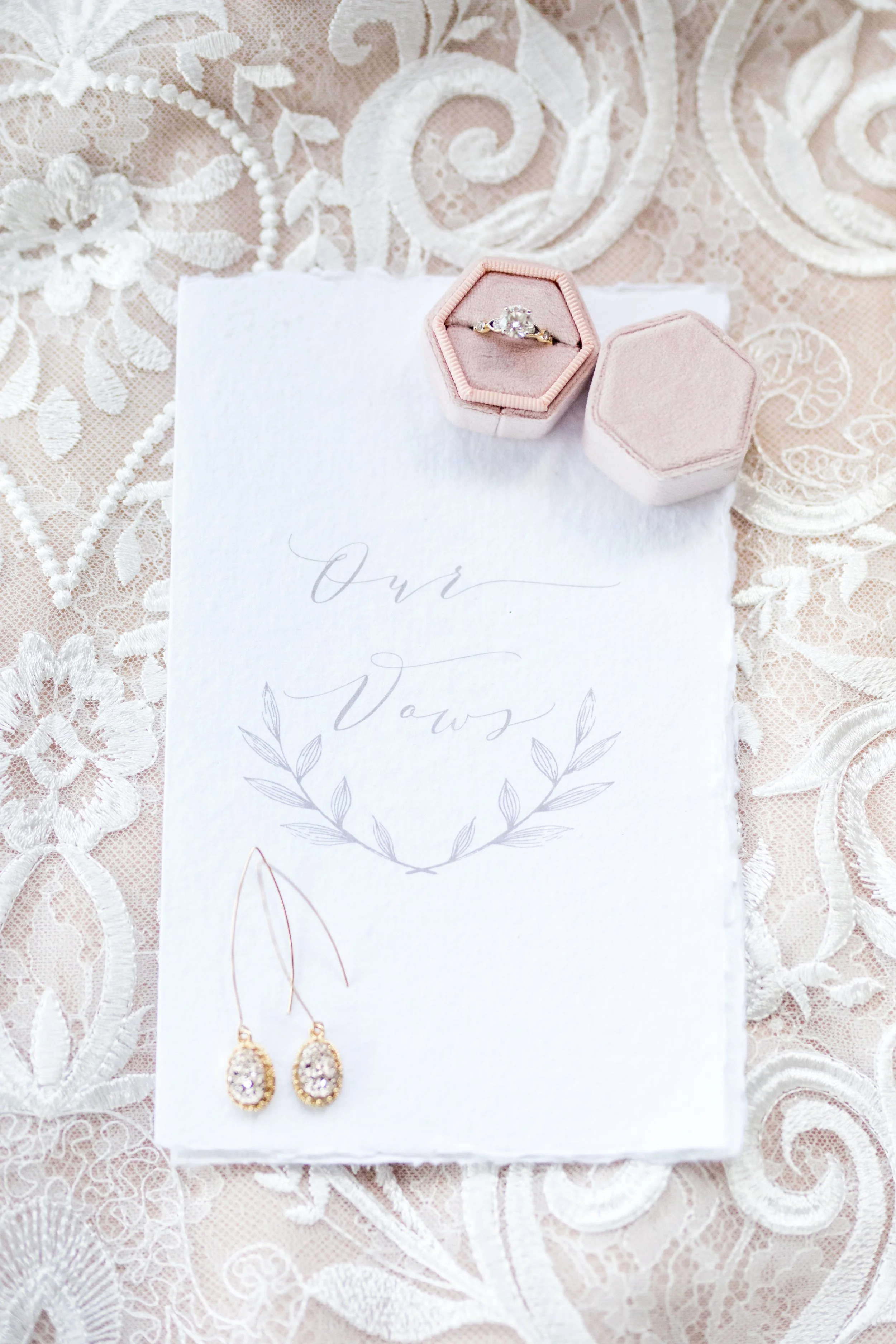 Jacqueline luxury wedding invitation suite featuring pink letterpress, pink silk ribbon, blush envelope with watercolor monstera envelope liner. Handmade paper vow book, velvet pink ring box, monogram garter and pink satin shoes