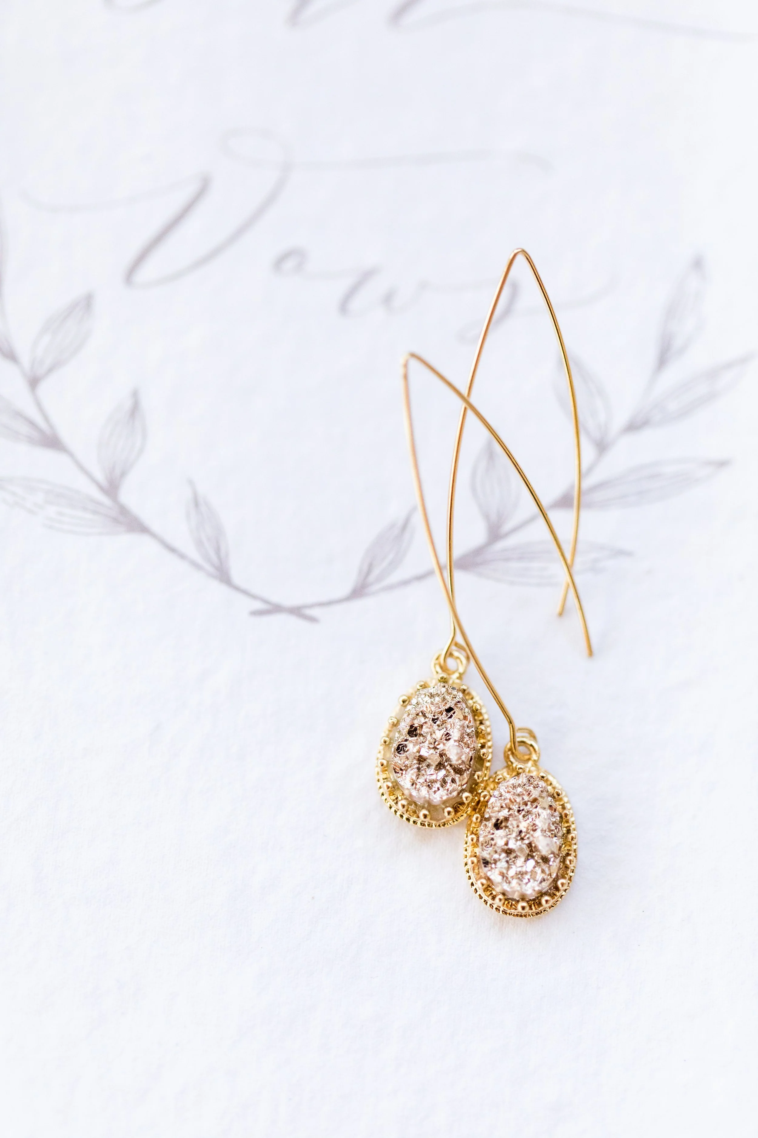 Jacqueline luxury wedding invitation suite featuring pink letterpress, pink silk ribbon, blush envelope with watercolor monstera envelope liner. Handmade paper vow book, velvet pink ring box, monogram garter and pink satin shoes