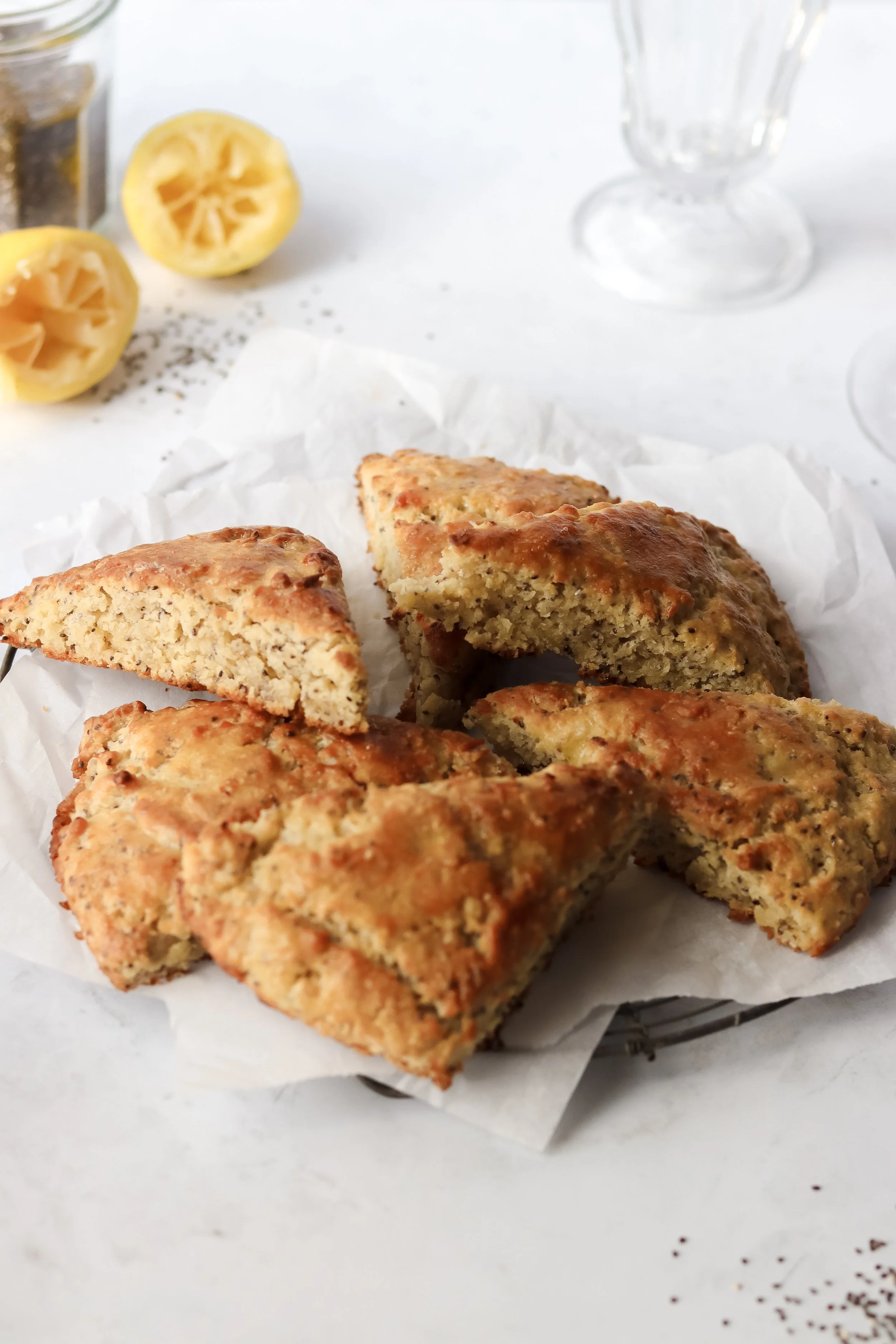 lemon chia scones, lemon poppy seed scones, gluten free, dairy free, vegan, cut and displayed on a round vintage rack with white parchment paper