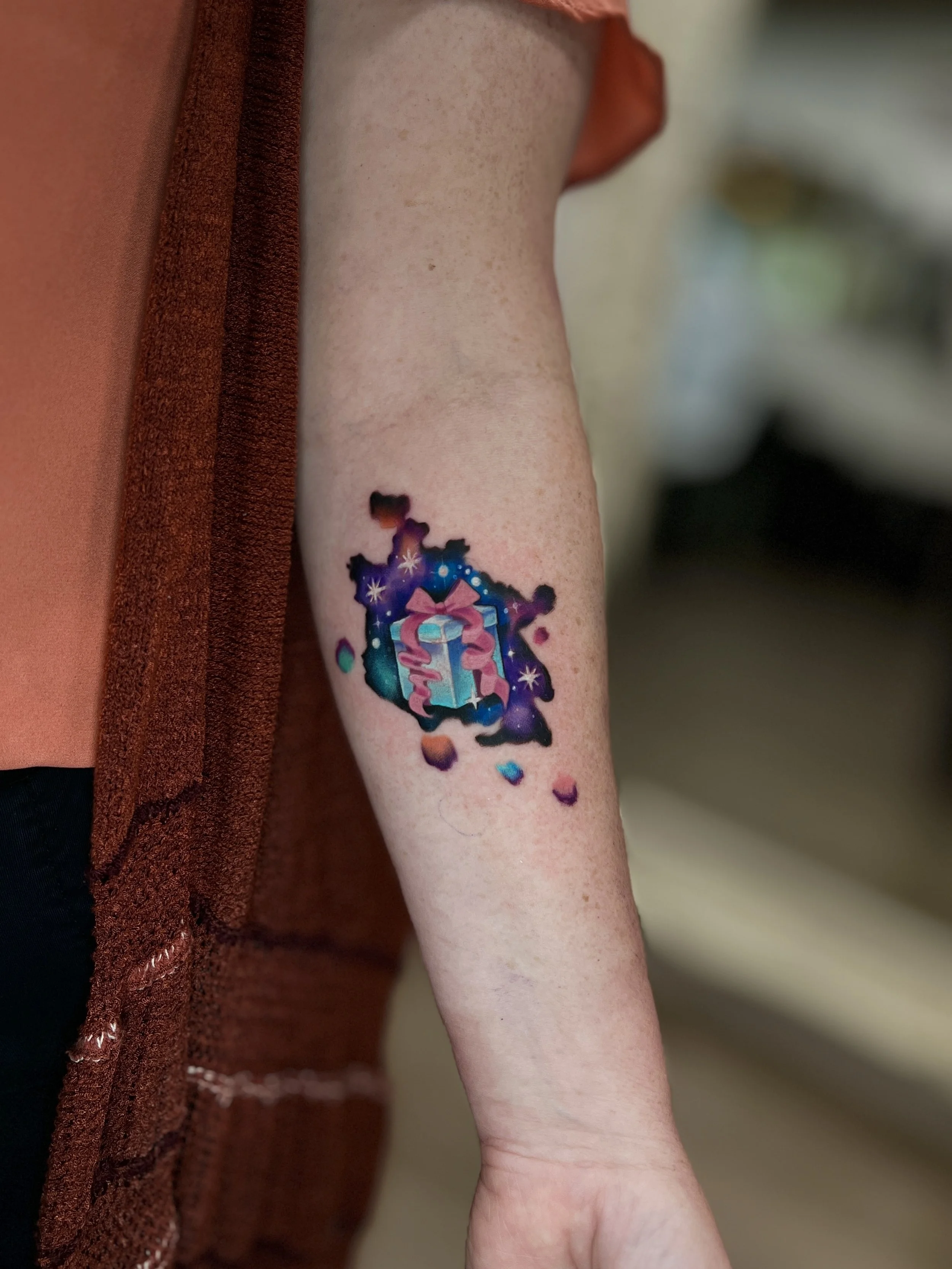 birthday present watercolor tattoo.jpeg