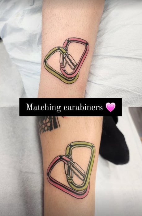 Tattoo of two interconnected carabiners in pink and green on a person's forearm with the caption "Matching carabiners" and a pink heart.