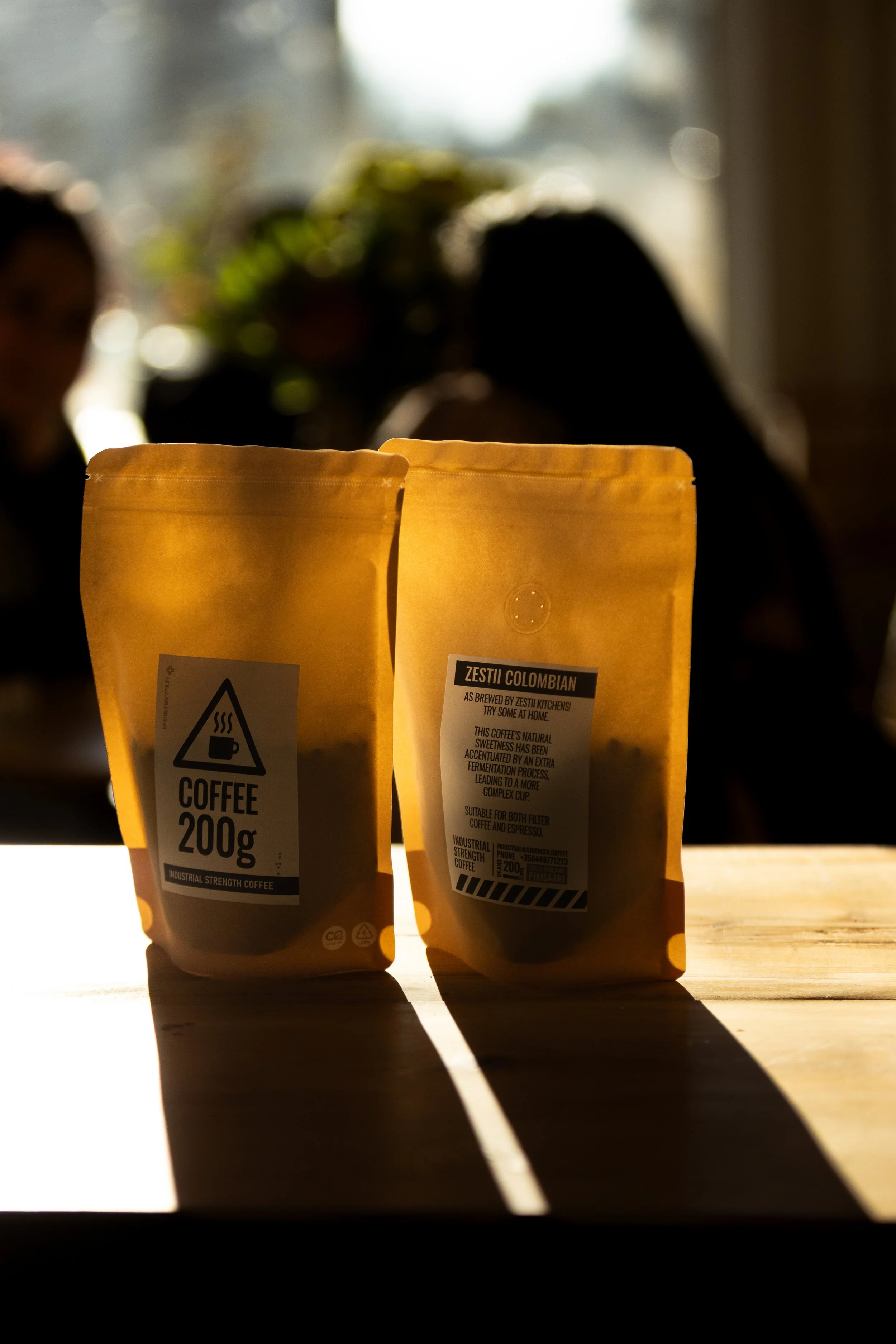 Two bags of ISC coffee. One is labeled 200g COFFEE. The other says Zestii Colombian.