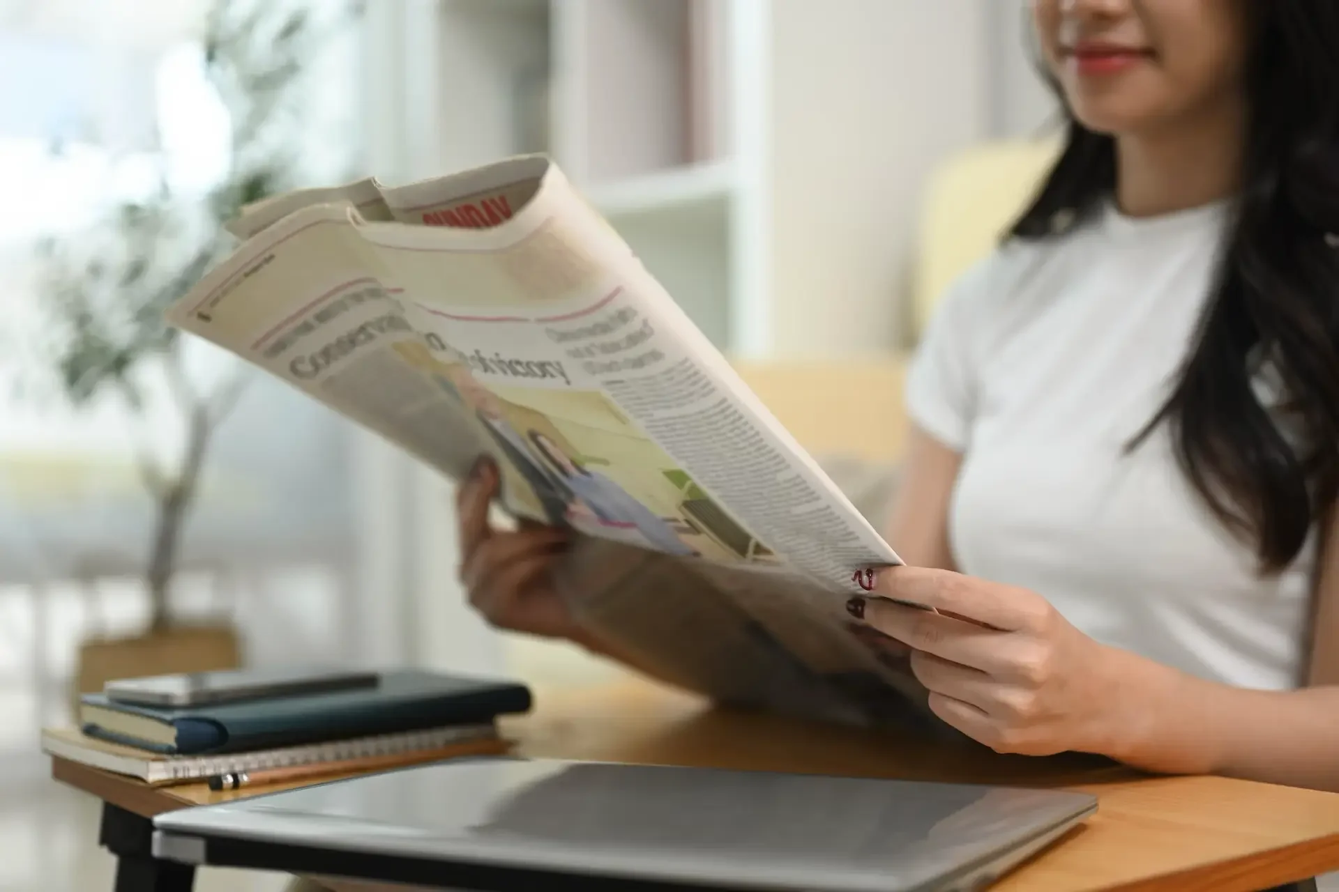 woman-reading-newspaper-while-relaxing-at-home-2026-01-06-09-51-04-utc.webp