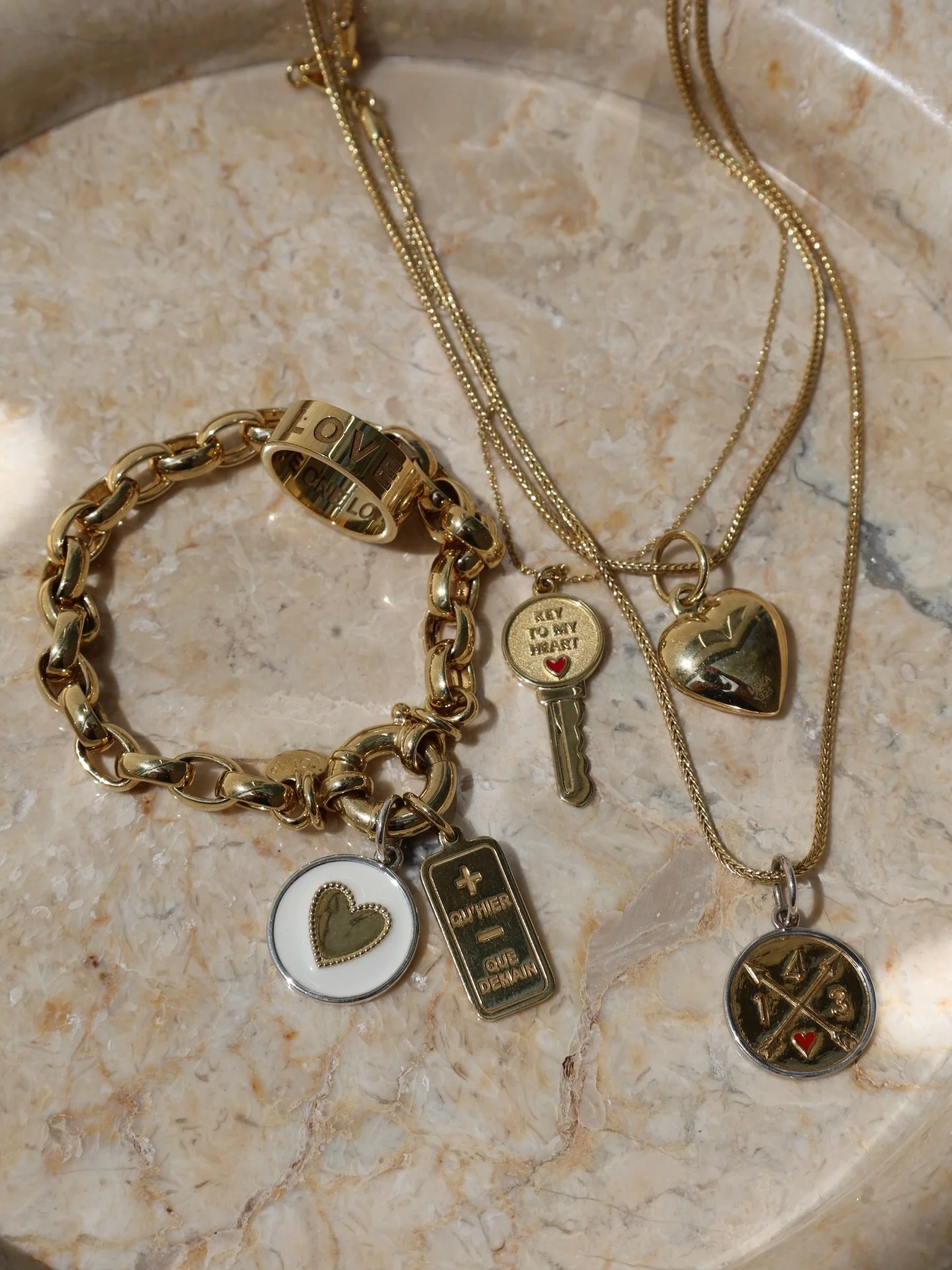 Mixing heart and love symbols is the perfect way to layer your story! Combining shapes, sizes, and finishes creates a look that feels playful yet polished, letting each pendant shine while coming together as a collection that&rsquo;s entirely you. ❤️