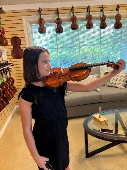 Figuring out the size for her first viola (at local shop)