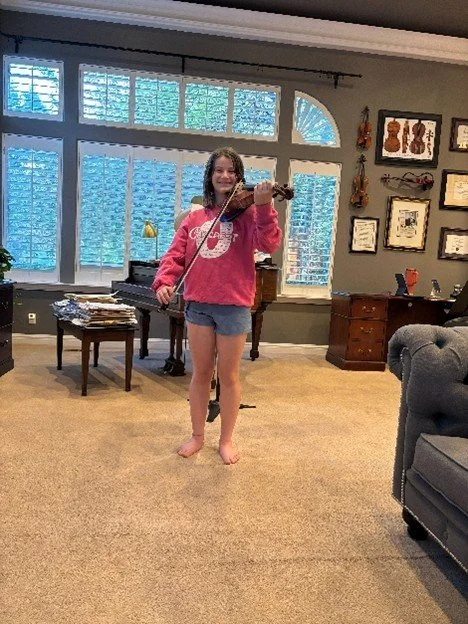 Enjoying her Viola at lessons