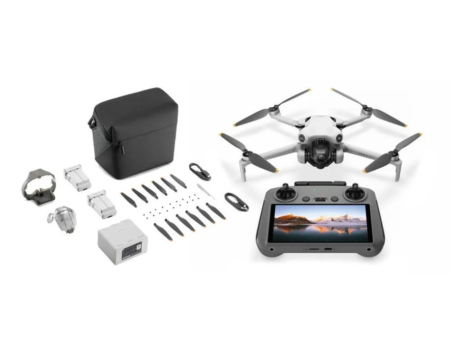 Drone kit with controller, drone, carrying case, battery charger, screwdriver, USB cables, battery packs, propellers, and screws.