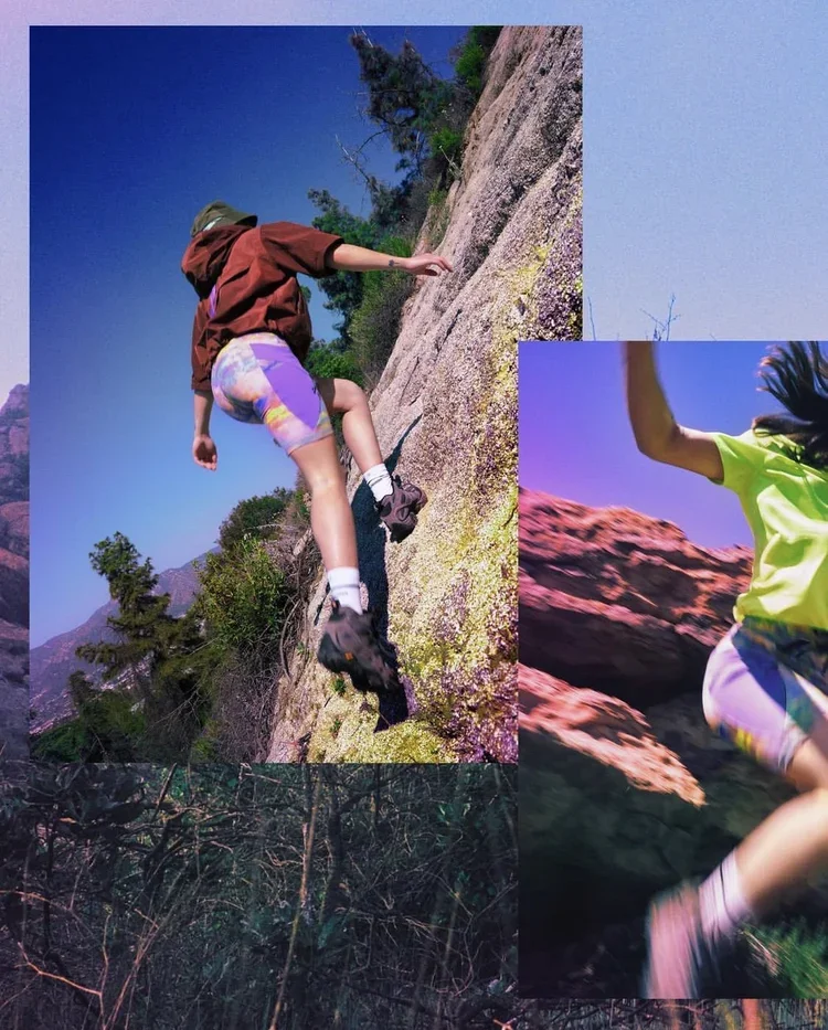 Two children climbing and running outdoors on rocky terrain with trees and mountains in the background.