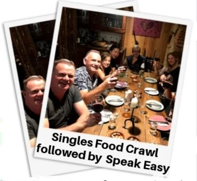 Group of people enjoying dinner at a restaurant, holding wine glasses, with a caption about a singles food crawl.