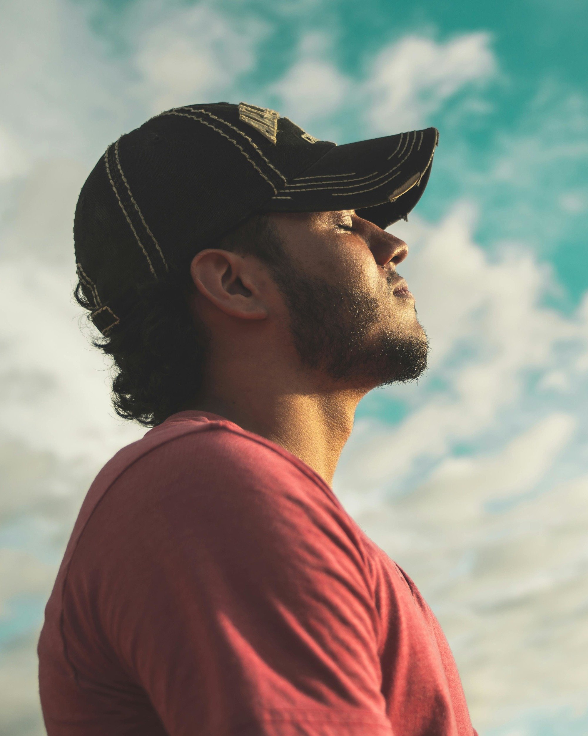 man wearing black cap with eyes closed