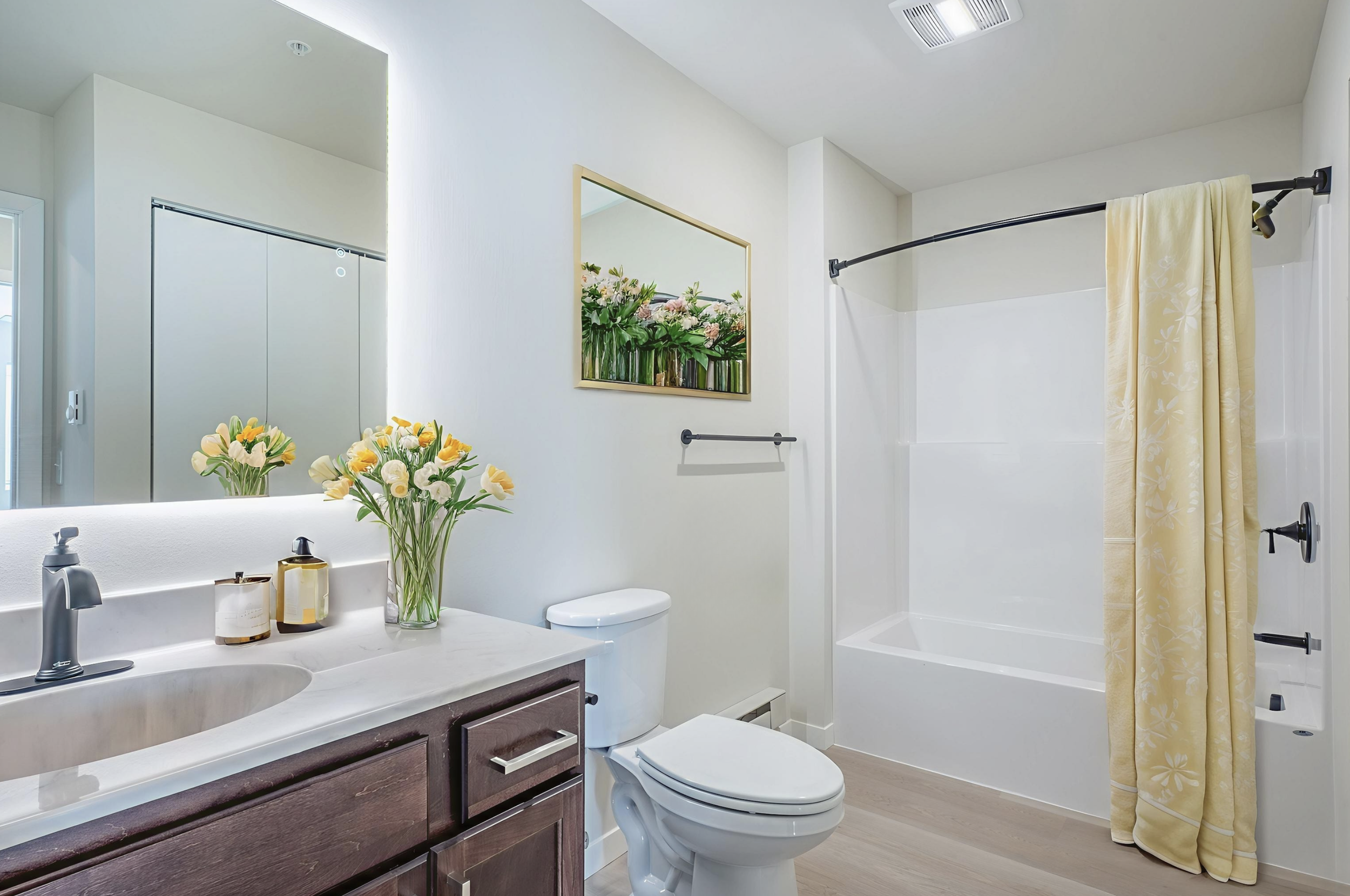 Spacious bathroom with backlight mirrors and modern fixtures at The Arnie in Rio Wisconsin