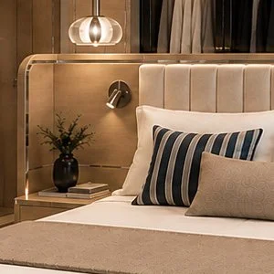 Blue World Voyages one-bedroom residence bedroom concept with built-in wardrobes, nautical bedding and a blue upholstered bench.