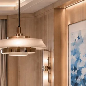 Blue World Voyages one-bedroom cruise residence concept with a cream sectional, dining nook and ocean-view balcony.