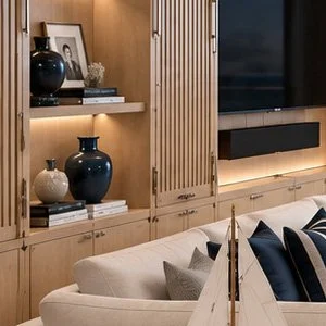 Blue World Voyages penthouse living room concept viewed toward the ocean, with built-in shelving and balcony seating.
