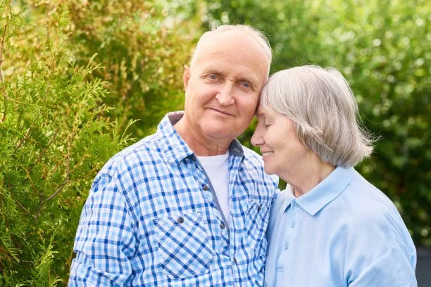 Older adult couple hugging 