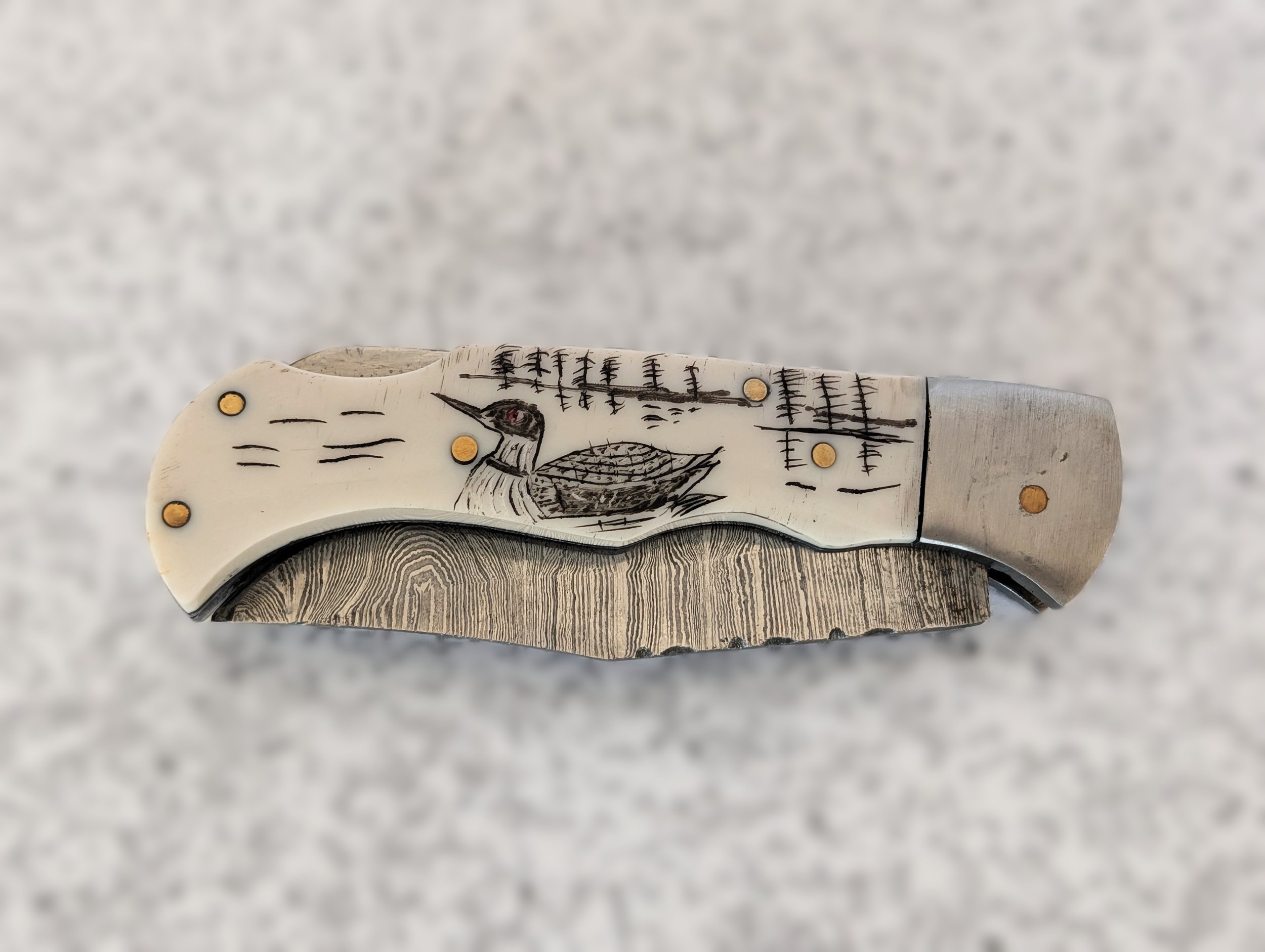 Scrimshaw etching on pocketknife, by Francois Lamothe