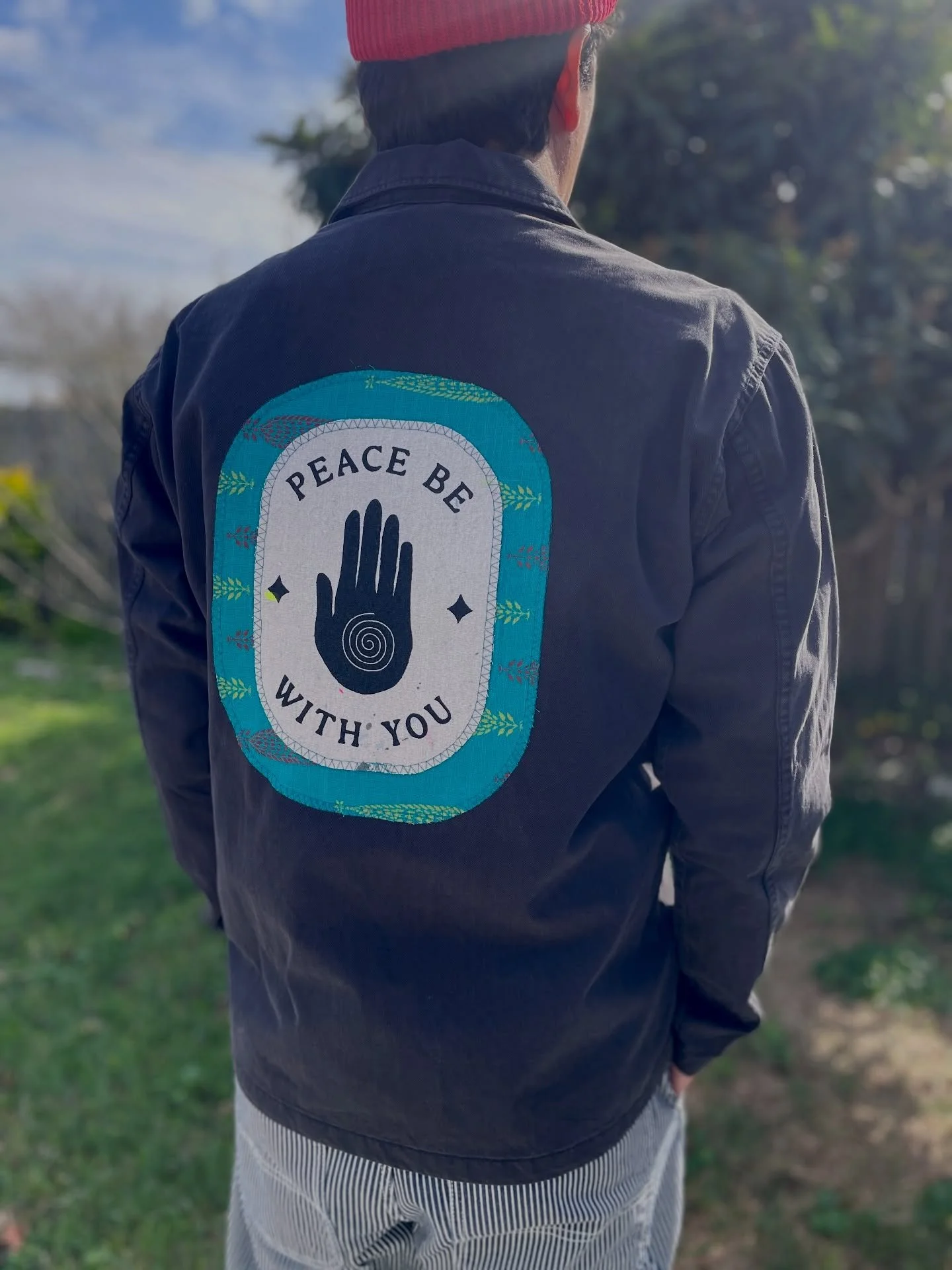 @aimee_sanchez_art and I upcycled some pieces that we did custom embellishments on and made back patches from old painted drop cloths that we screen printed by hand. Some even have hand sewn, custom Sashiko stitching. Also, the orange and teal backgr