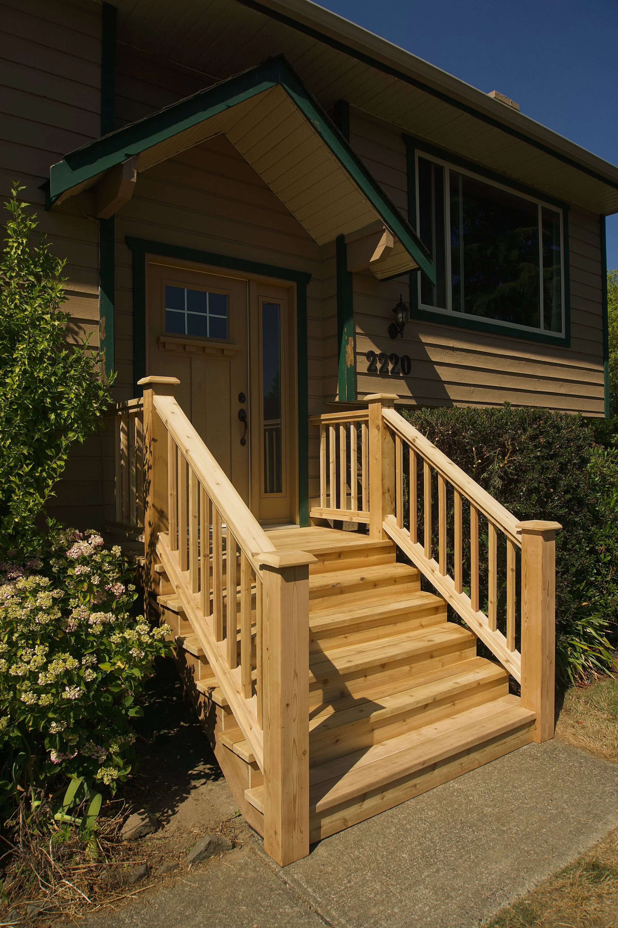Red cedar front entryway stairs with railings and spindles in Sidney, BC