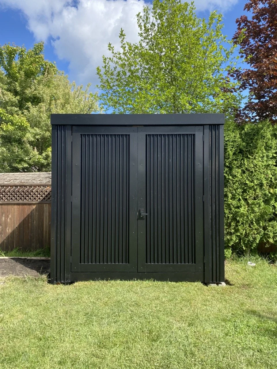 Metal storage shed, corrugated metal, black metal