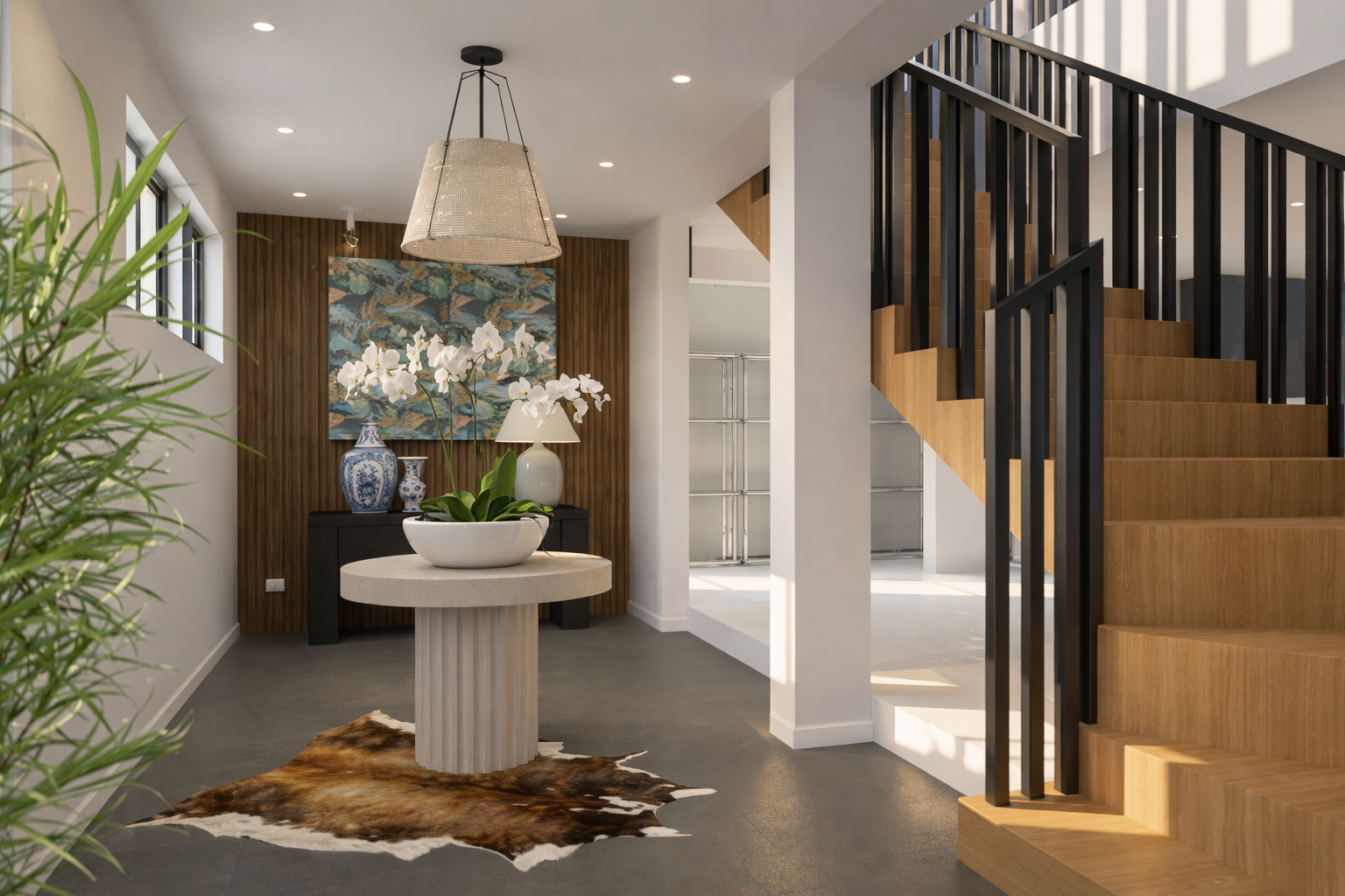 Modern foyer with staircase, sculptural pedestal with orchids, colorful artwork, and decorative vases.