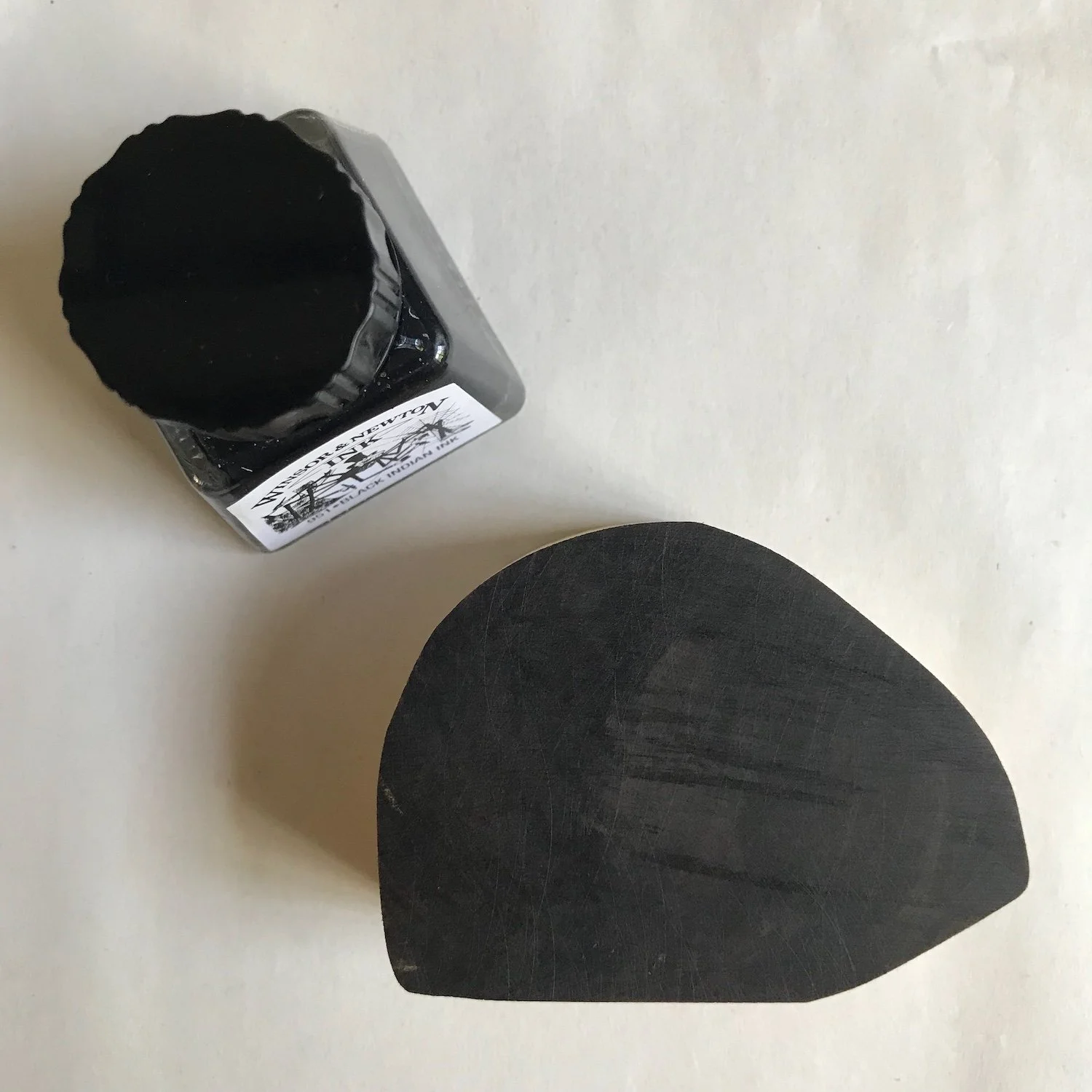 A wood engraving block darkened with Indian ink.